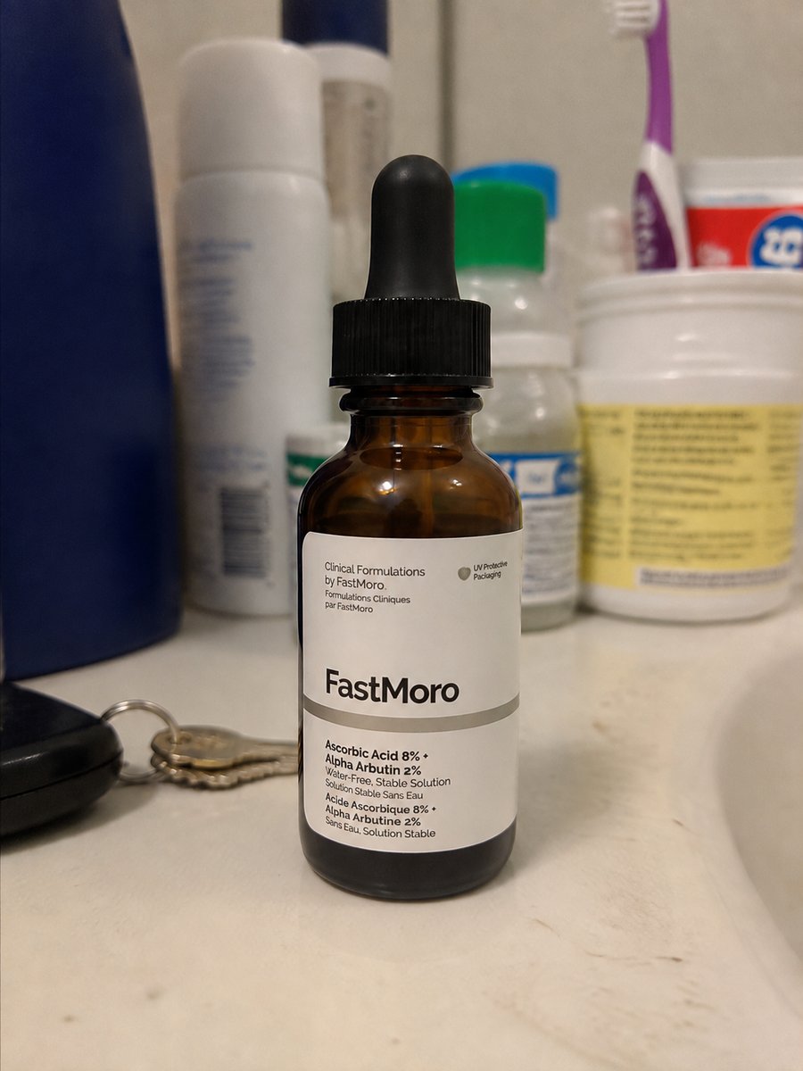 Plain product photo of a serum bottle on a bathroom counter